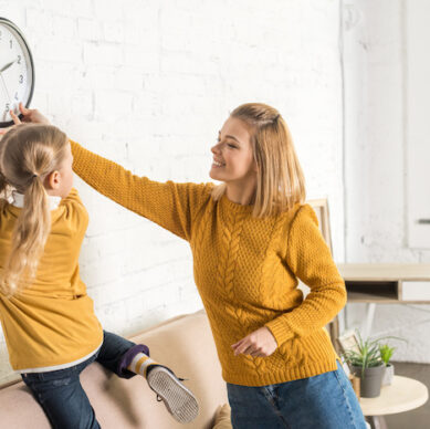 Mother teaching daughter about daylight savings.