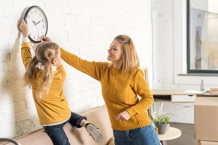 Mother teaching daughter about daylight savings.